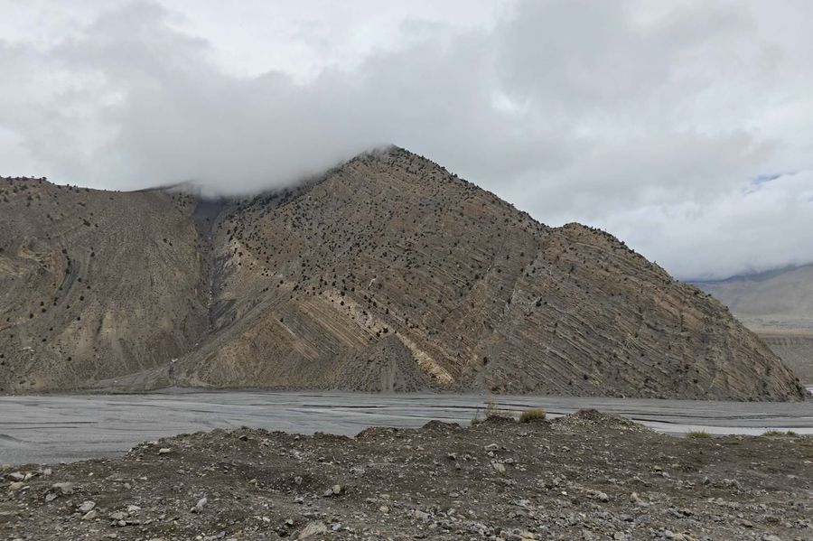 Motorcycle approaching a fortified settlement in the Himalaya